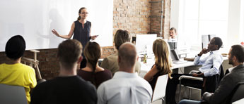 Tuition assistance icon and photo of lady talking to a group