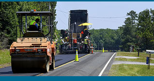 Phot of equipment paving a two lane road