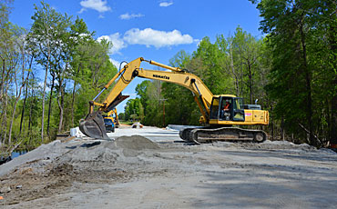 image of track hoe working on a new roadway