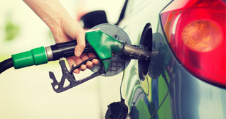 person pumping gas into their car