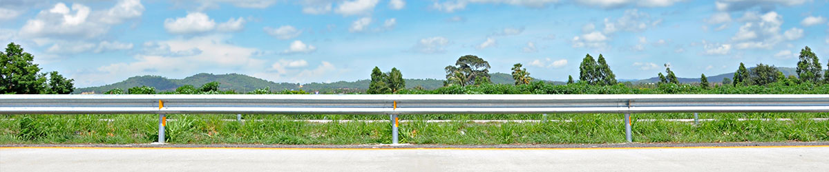 roadside raining with mountains in the background